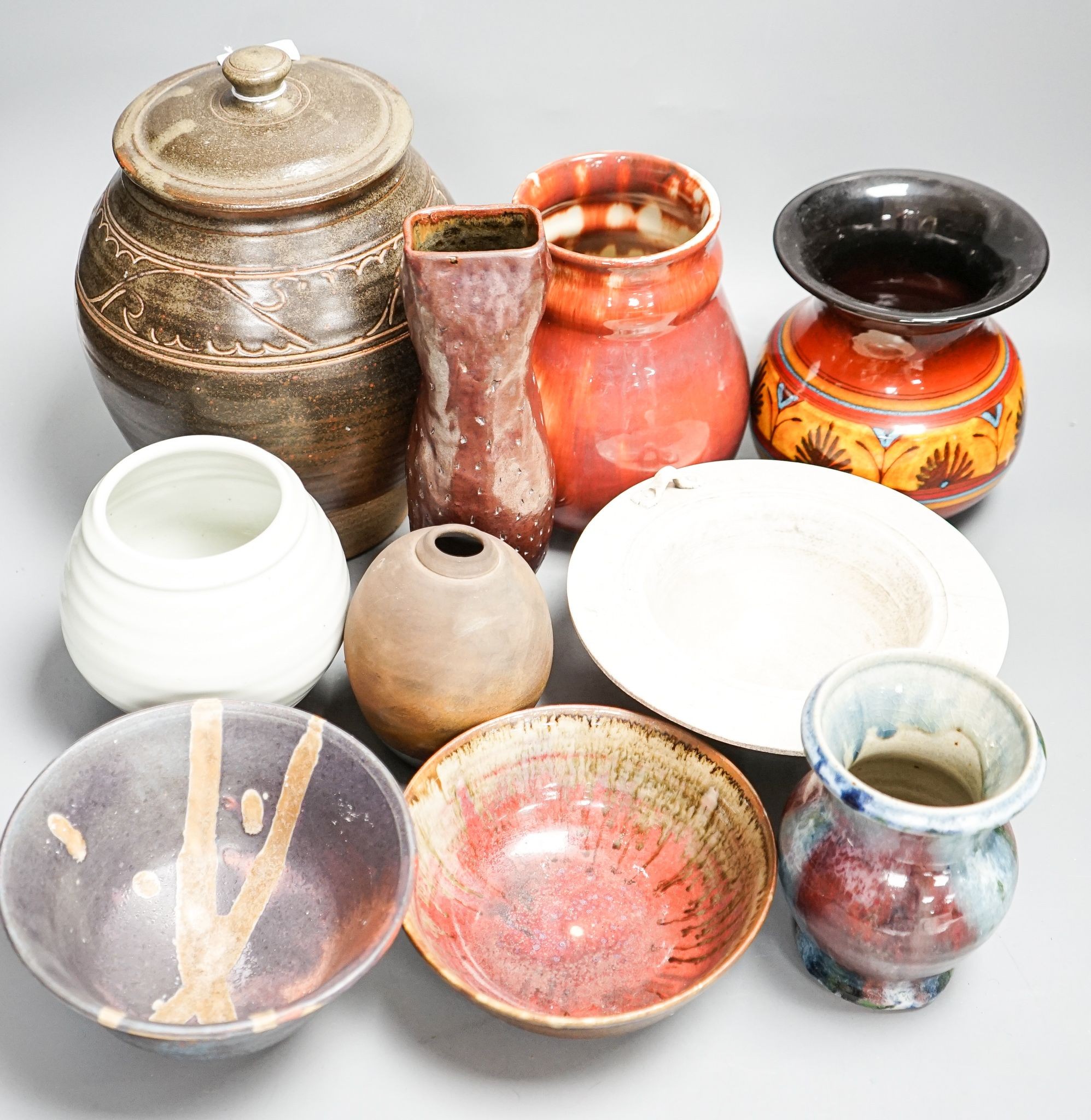 A group of studio pottery including a jar and cover, probably Norah Braden, 25 cm